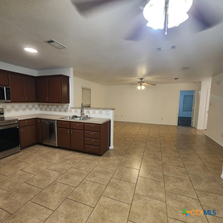 1111 Travis Circle Copperas Cove, TX 76522 - Photo 7 of 24 a kitchen with a sink a cabinets and window