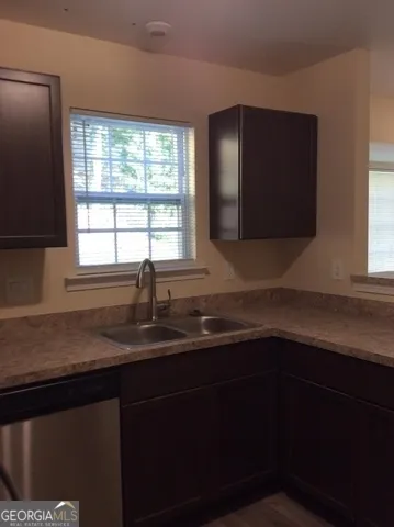 a kitchen with a sink and a window