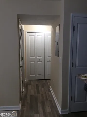 a view of a hallway with wooden floor