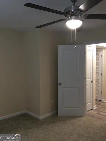a view of a chandelier fan in the hallway