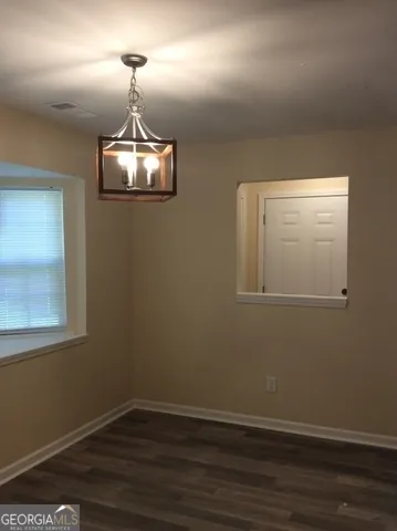 a view of a room with wooden floor fan and window