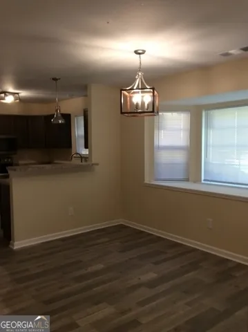 an empty room with wooden floor and window