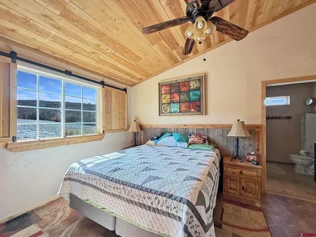 a bedroom with a bed dresser and a window