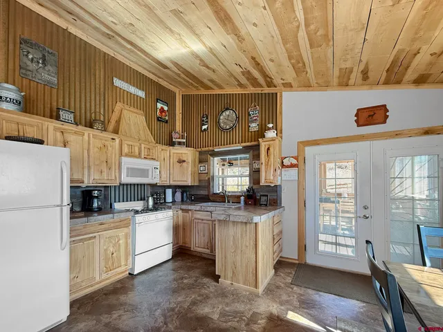 a kitchen with stainless steel appliances granite countertop a sink and a stove