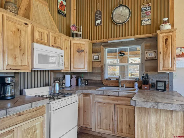 a kitchen with sink and large window