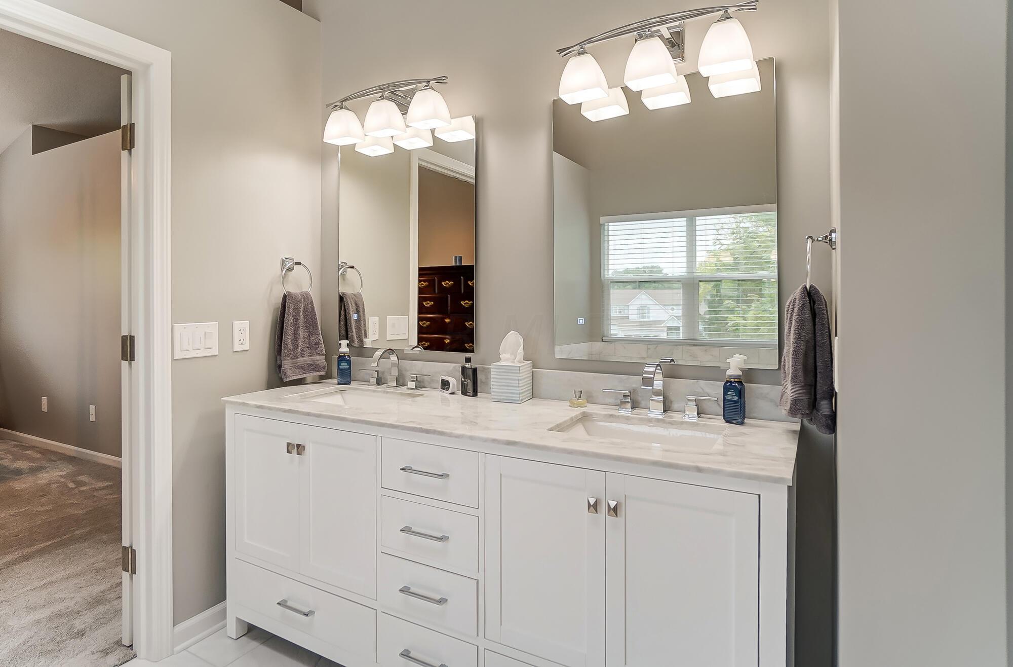 5674 Steward Road Galena, OH 43021 - Photo 52 of 82 Gorgeous bathroom full of new upgrades...Carrerra marble countertops, his/her niches in shower, heated flooring, lighted mirrors