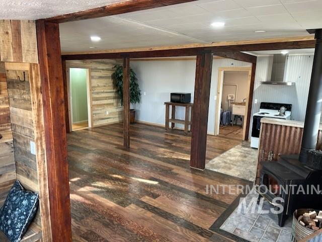 820 Sweeney Road Elk City, ID 83525 - Photo 11 of 45 Living area with a wood stove, wood finished floors, wood walls, and recessed lighting