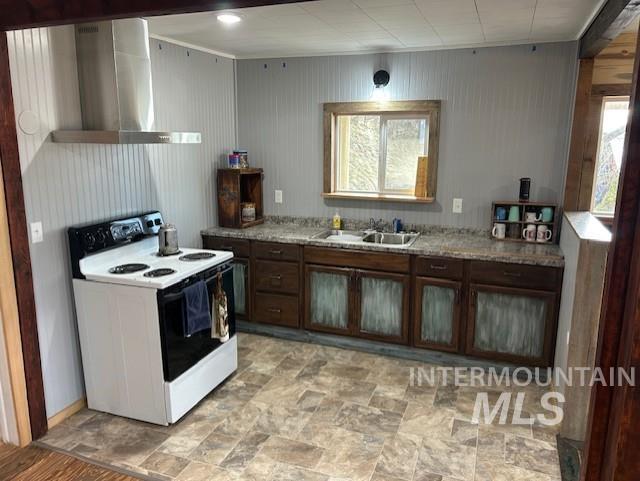 820 Sweeney Road Elk City, ID 83525 - Photo 14 of 45 Kitchen featuring dark wood finish cabinets, electric range, stone finish flooring, and light countertops