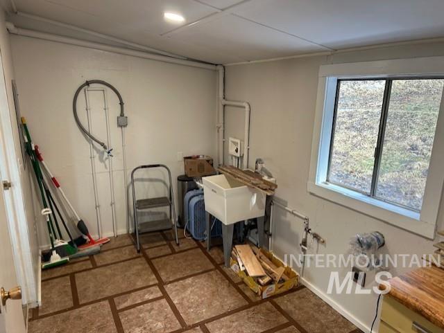 820 Sweeney Road Elk City, ID 83525 - Photo 19 of 45 Laundry room featuring baseboards and a sink