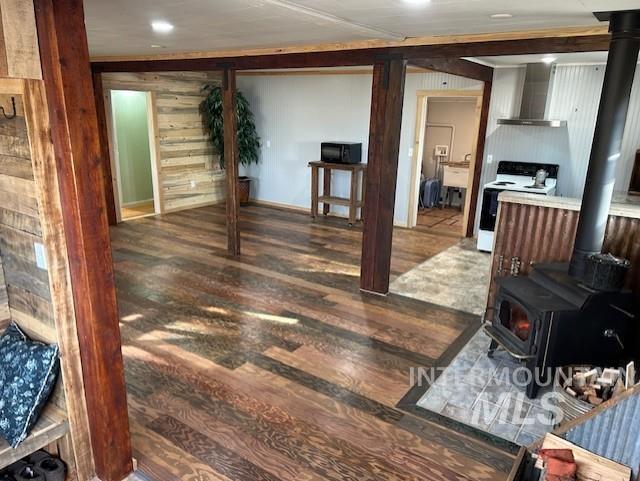 820 Sweeney Road Elk City, ID 83525 - Photo 5 of 45 Living area featuring a wood stove, wood finished floors, and recessed lighting