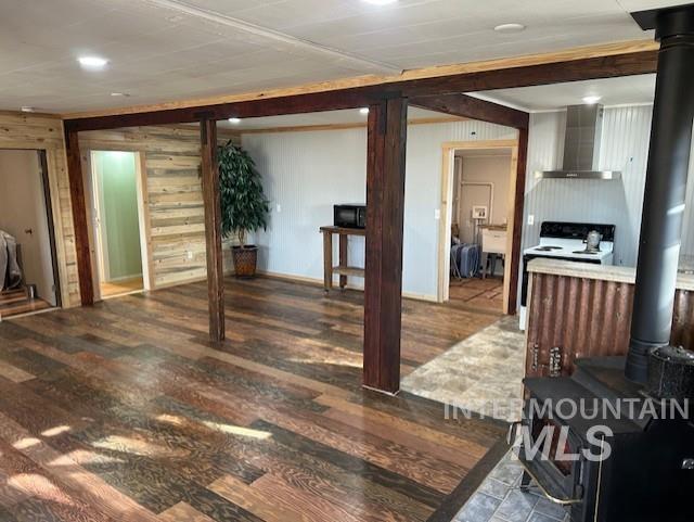 820 Sweeney Road Elk City, ID 83525 - Photo 7 of 45 Living room with a wood stove, dark wood-style floors, wooden walls, and recessed lighting