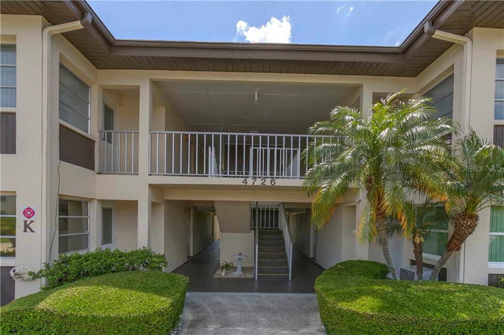 4726 Marine Parkway, Unit 104 New Port Richey, FL 34652 - Photo 1 of 1 a view of a house with a small yard and plants