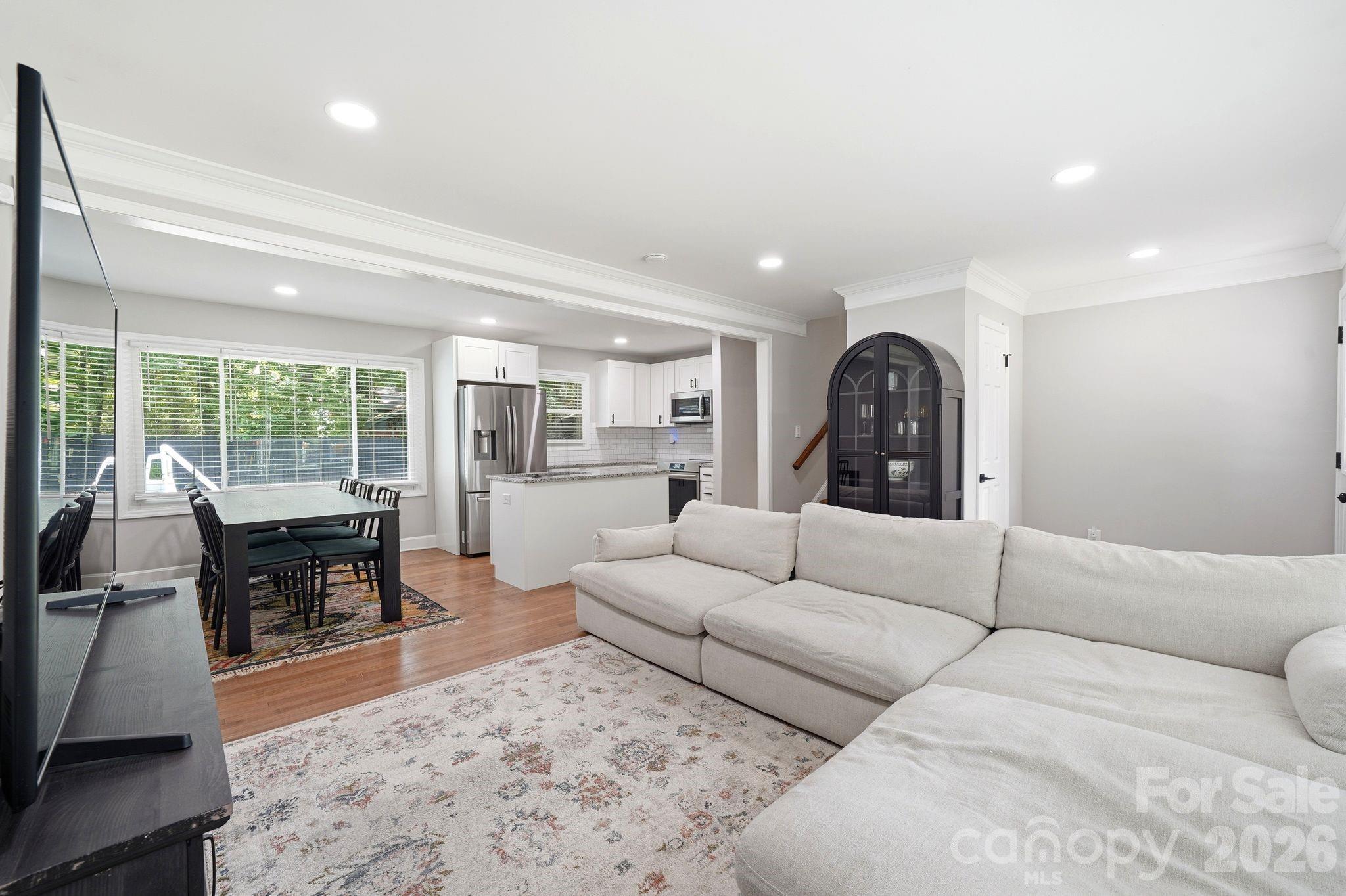 7552 Idlewild Road Charlotte, NC 28212 - Photo 7 of 40 a living room with furniture and a large window