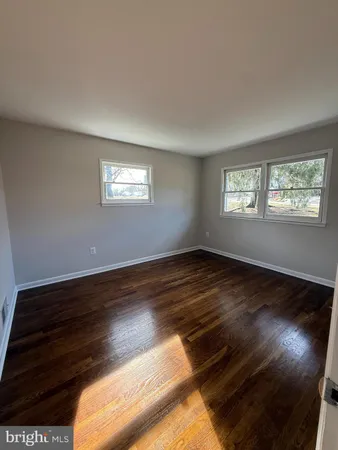 a view of wooden floor and windows in a room