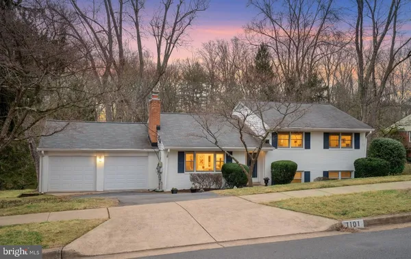 a front view of a house with garage and yard