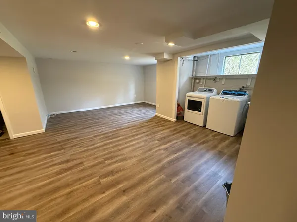 a view of a kitchen with wooden floor and a sink