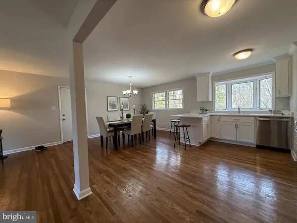a view of a dining room with furniture and chandelier