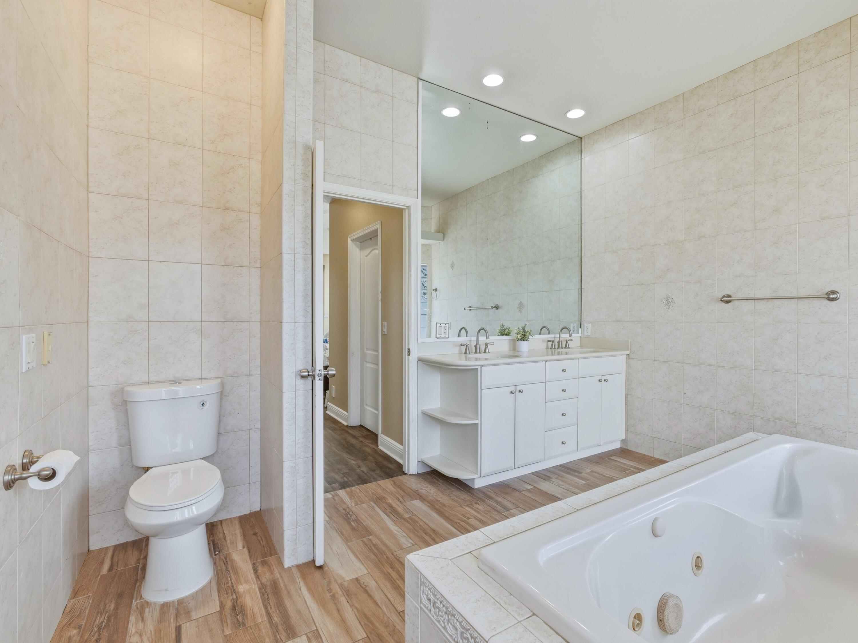 18852 43rd Road North The Acreage, FL 33470 - Photo 11 of 24 a bathroom with a sink a toilet and shower
