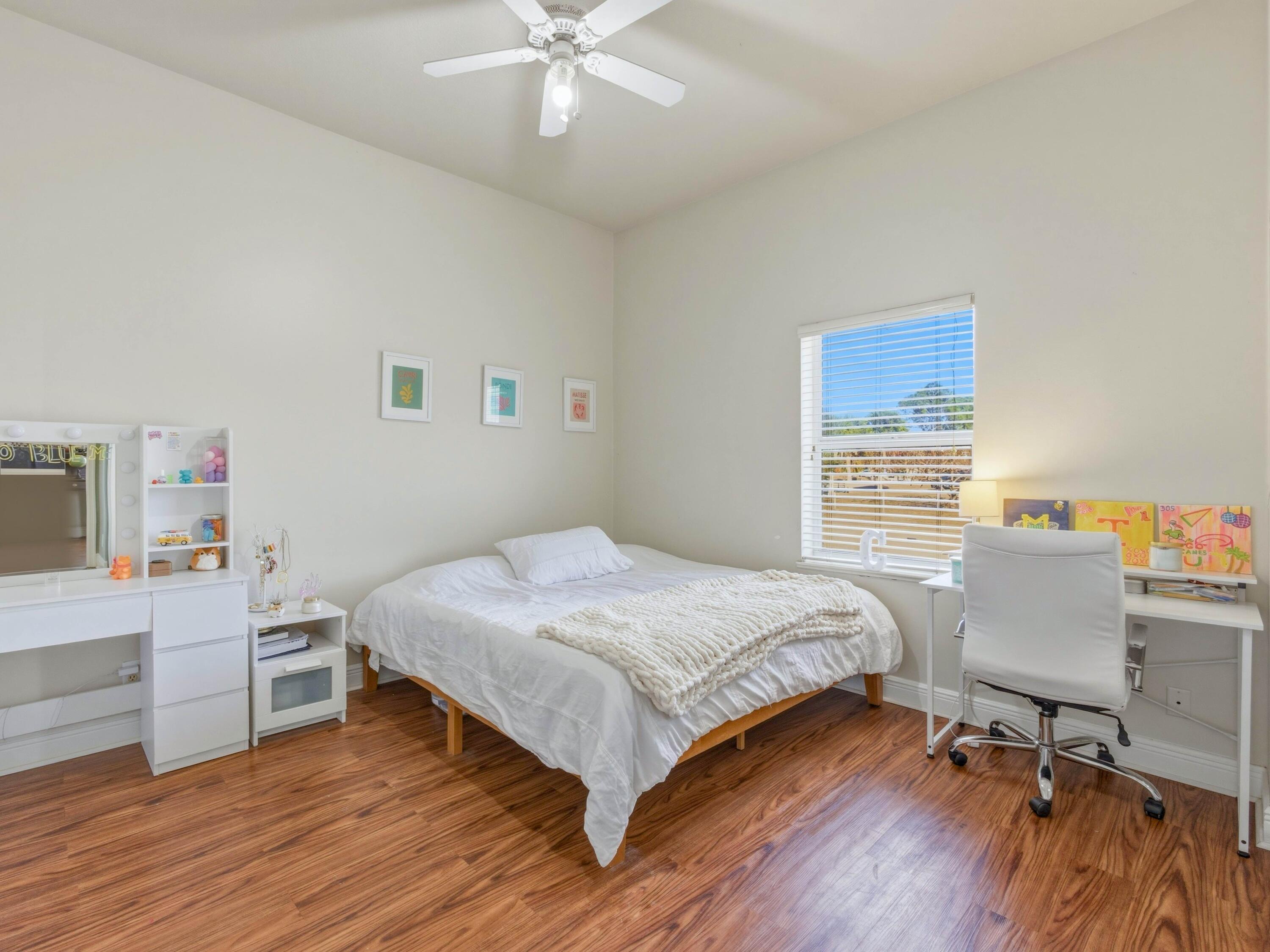 18852 43rd Road North The Acreage, FL 33470 - Photo 13 of 24 a bedroom with a bed and a desk