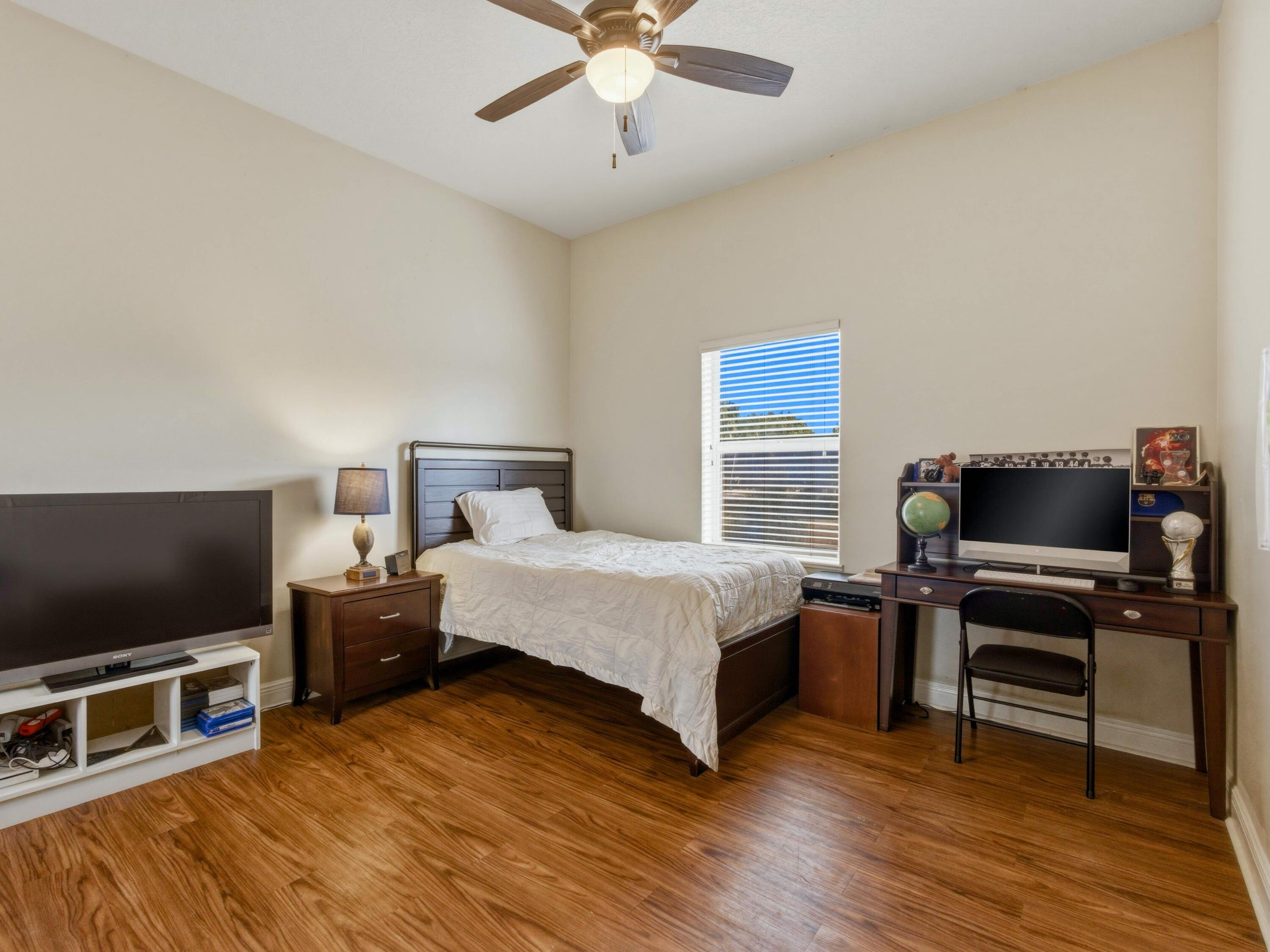 18852 43rd Road North The Acreage, FL 33470 - Photo 15 of 24 a bedroom with a bed and a flat screen tv