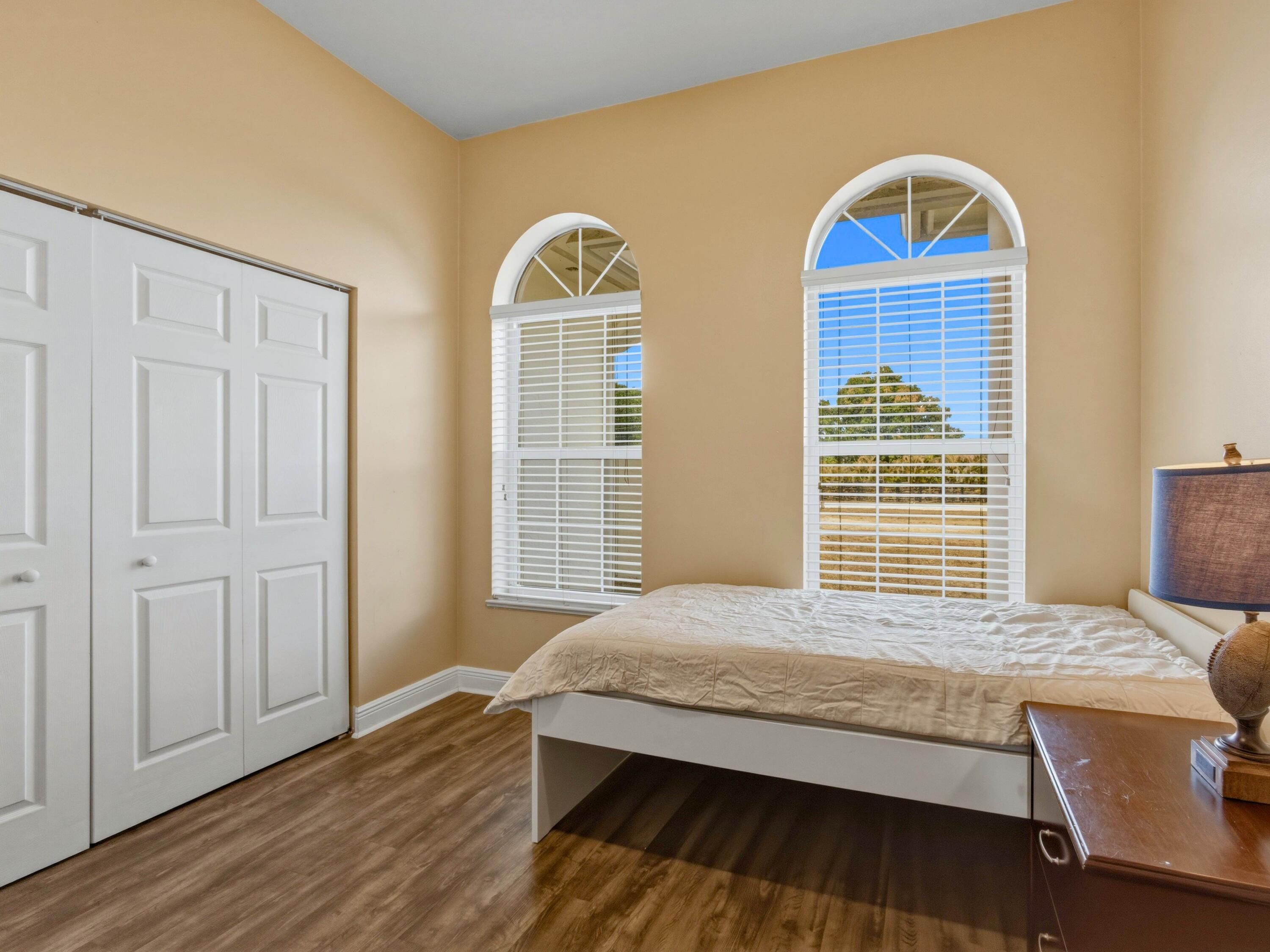 18852 43rd Road North The Acreage, FL 33470 - Photo 16 of 24 a bedroom with bed and wooden floor