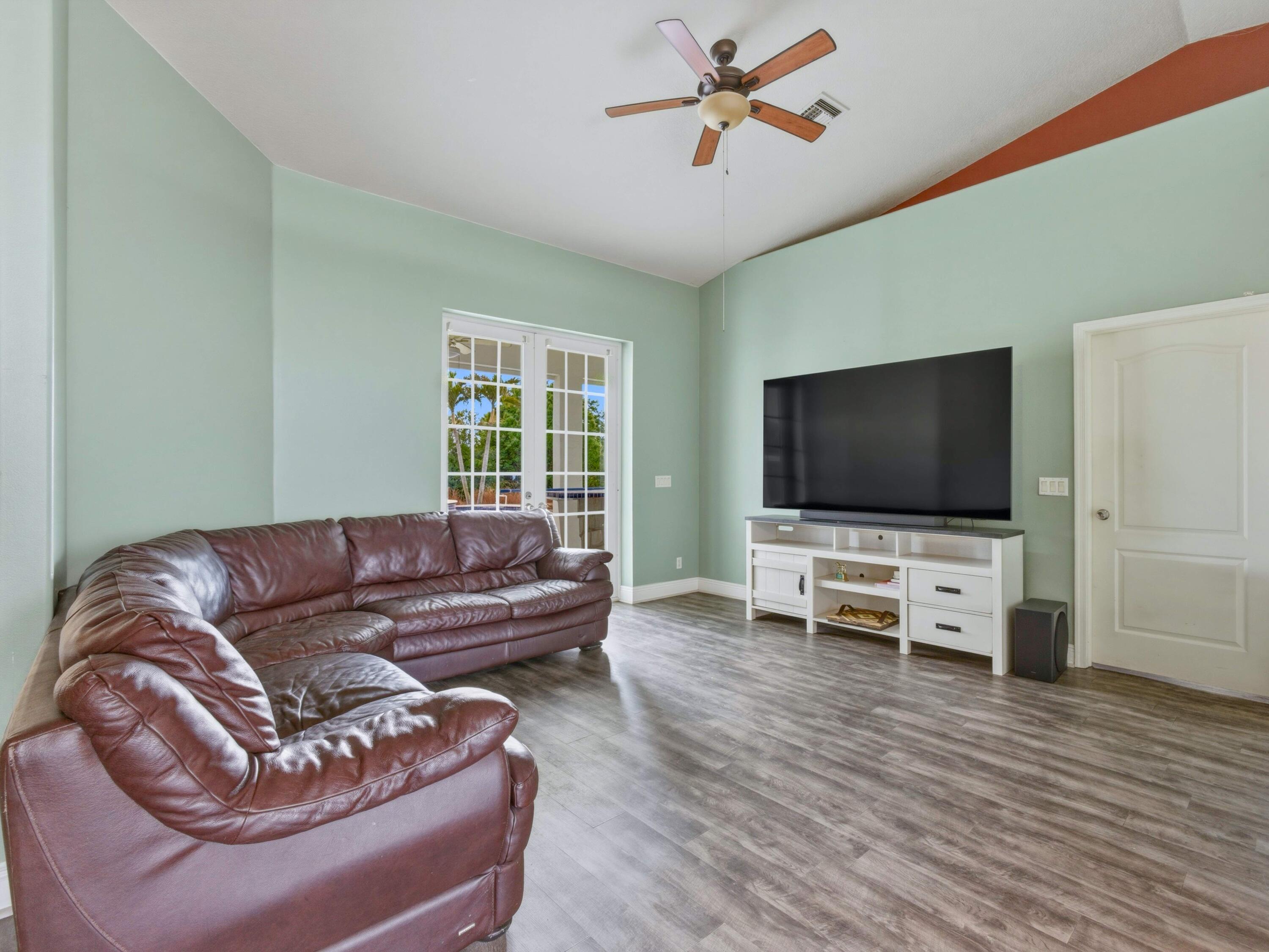 18852 43rd Road North The Acreage, FL 33470 - Photo 18 of 24 a living room with furniture and a flat screen tv