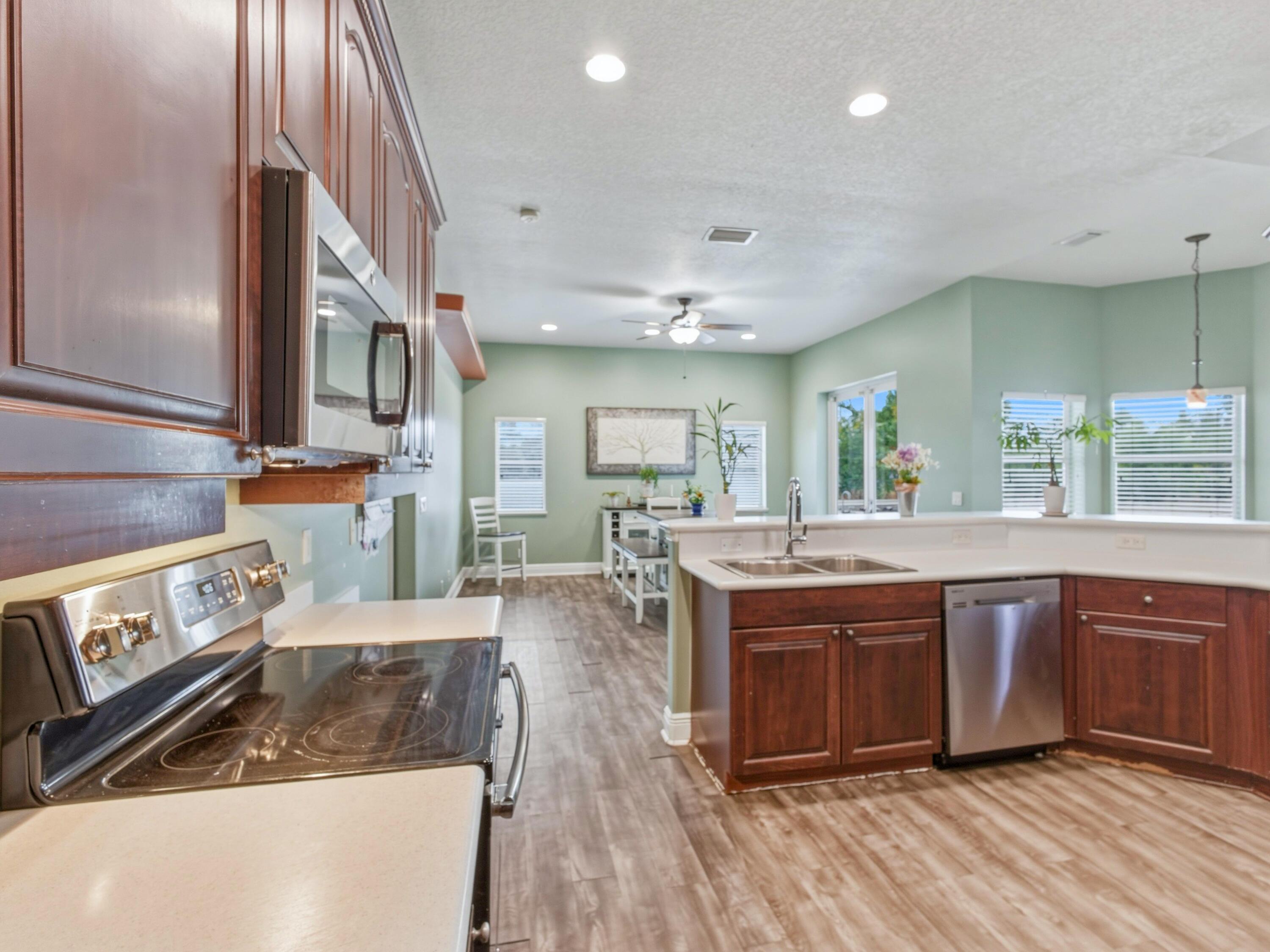18852 43rd Road North The Acreage, FL 33470 - Photo 4 of 24 a kitchen with stainless steel appliances granite countertop a stove and cabinets
