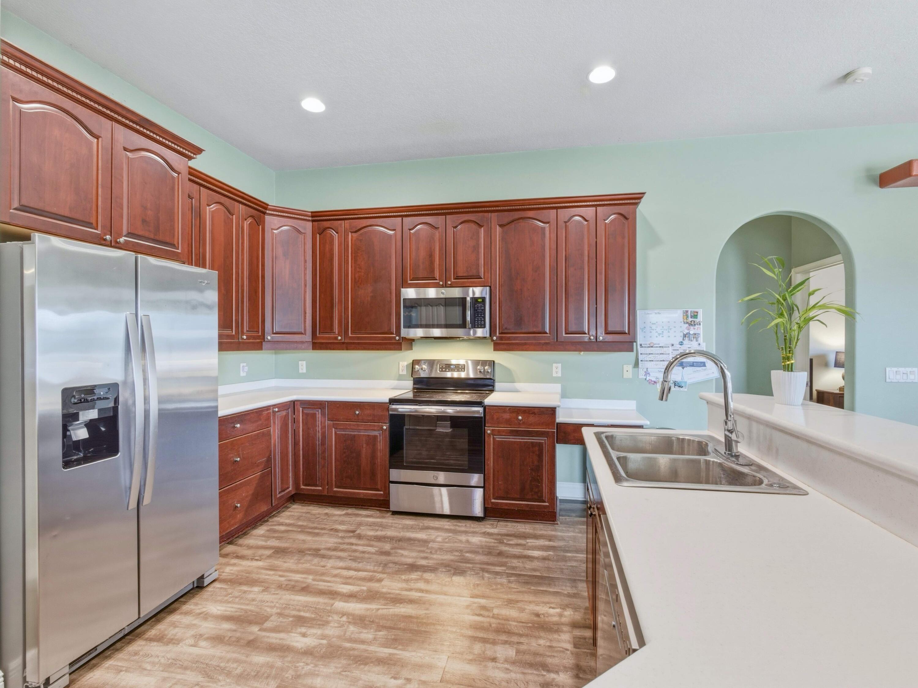 18852 43rd Road North The Acreage, FL 33470 - Photo 5 of 24 a kitchen with stainless steel appliances granite countertop a refrigerator sink and stove