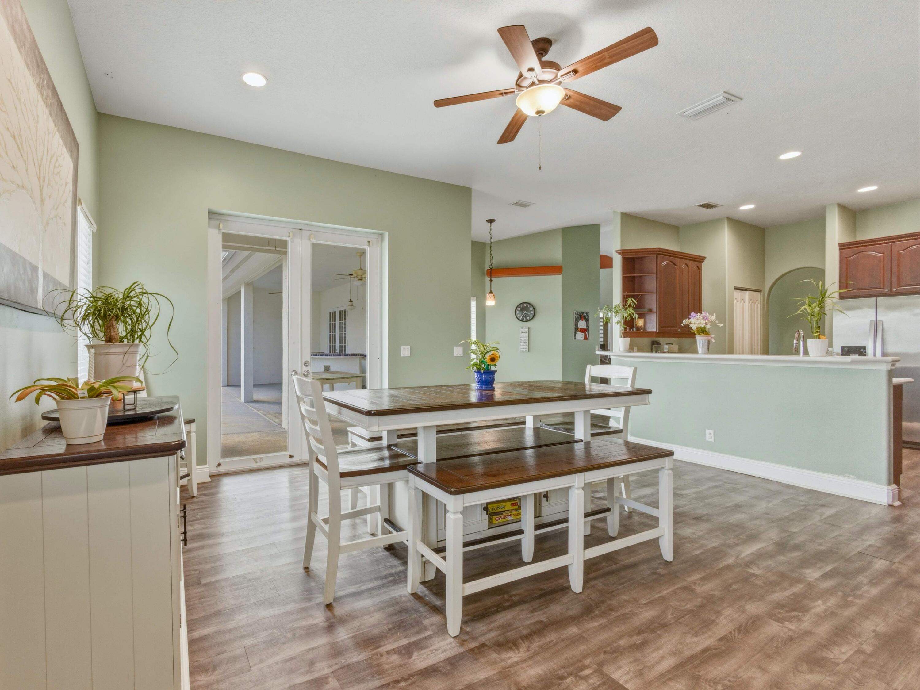 18852 43rd Road North The Acreage, FL 33470 - Photo 7 of 24 a living room with kitchen furniture and a wooden floor