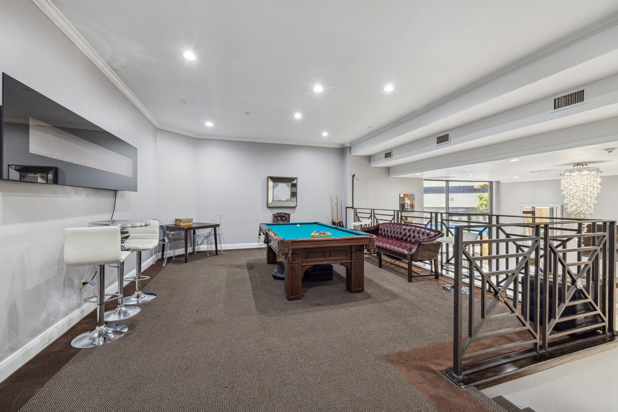 3350 McCue Road, Unit 1702 Houston, TX 77056 - Photo 4 of 7 a living room with lots of furniture and air hockey table