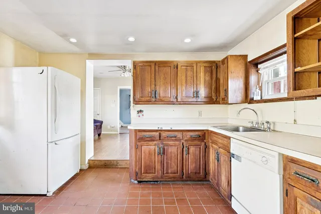 a kitchen with a sink appliances and cabinets
