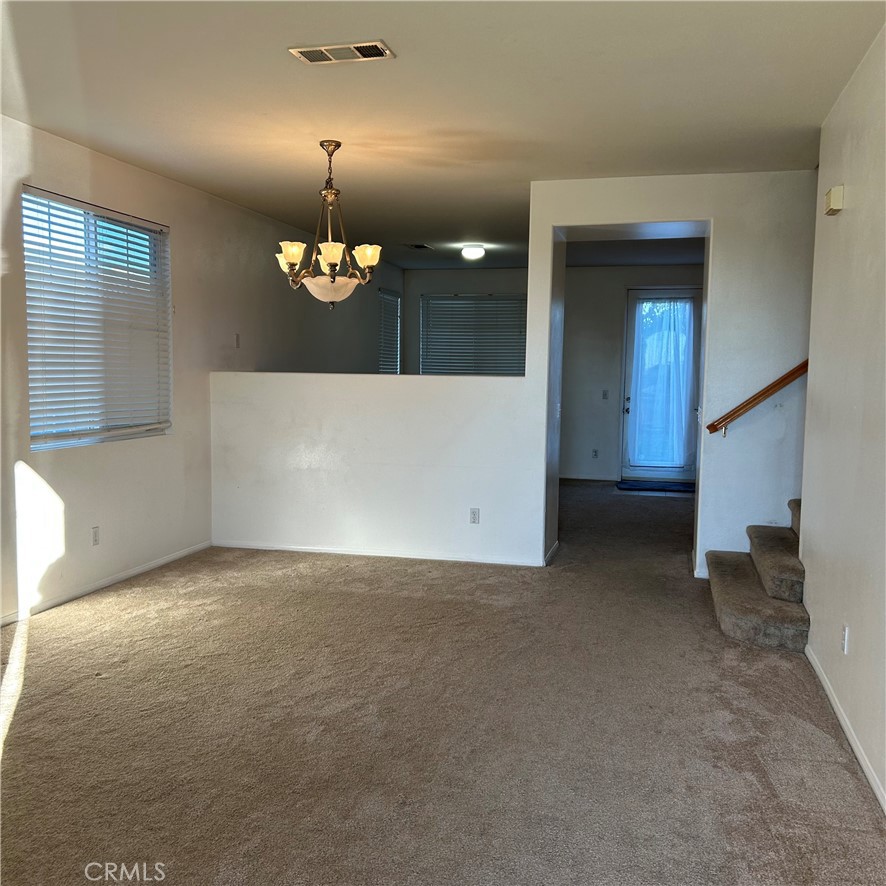 1538 Apple Canyon Road Beaumont, CA 92223 - Photo 3 of 23 a view of a hallway with a chandelier