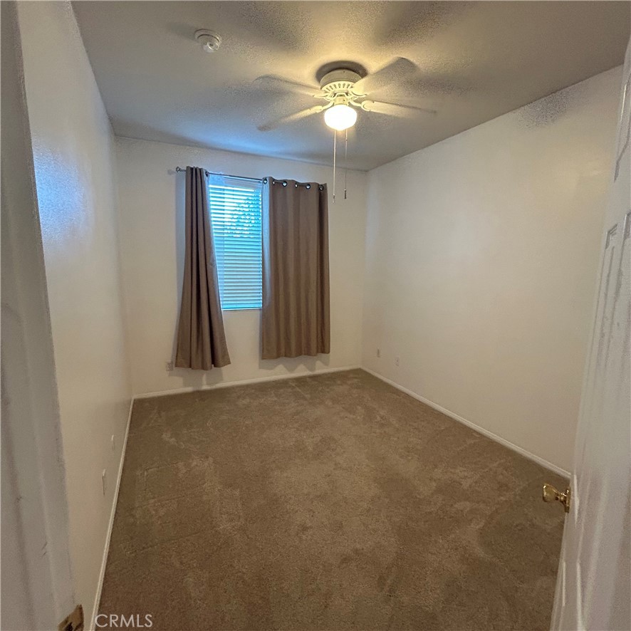 1538 Apple Canyon Road Beaumont, CA 92223 - Photo 7 of 23 an empty room with windows and fan
