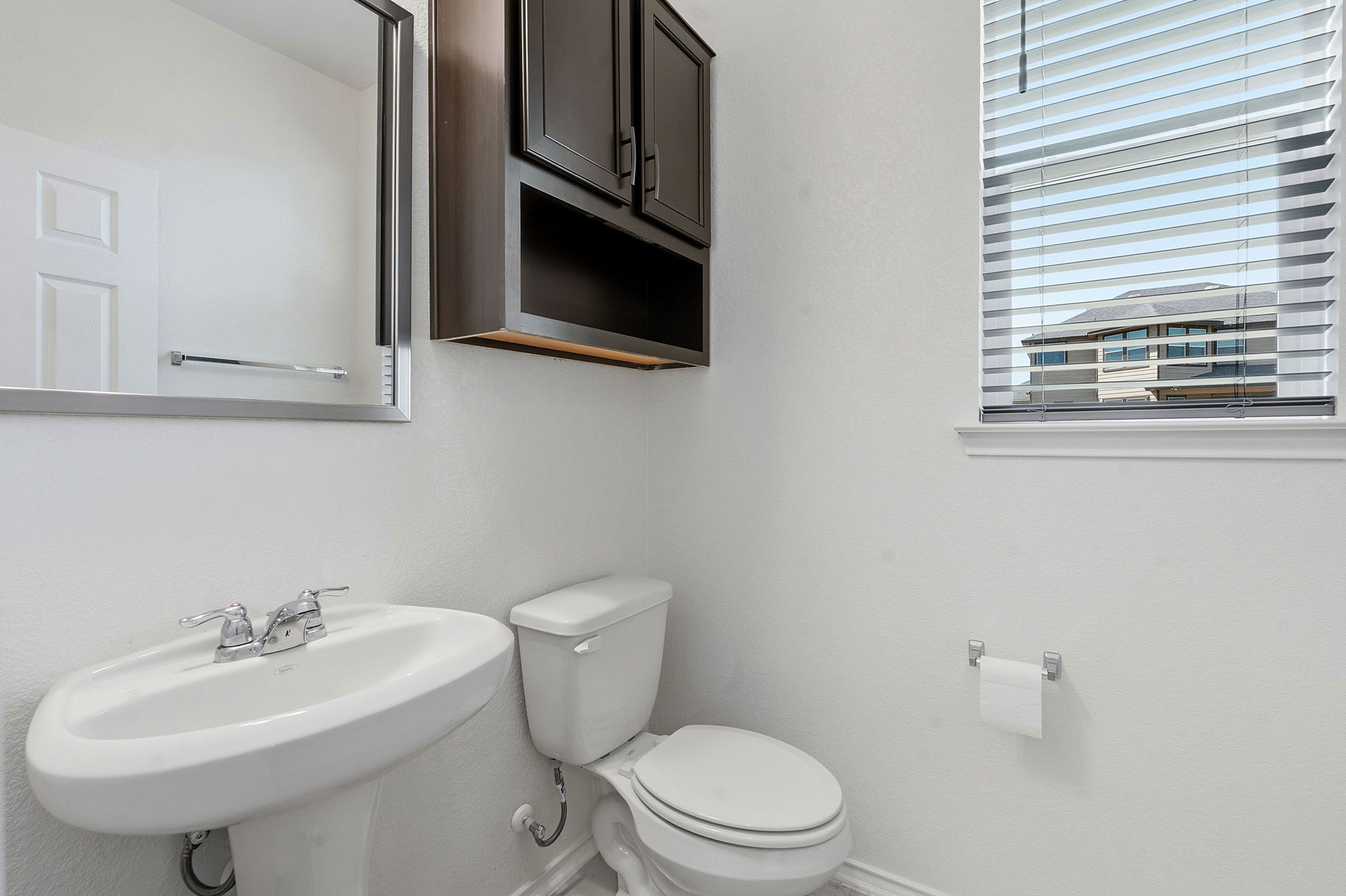 13928 Inaugural Street Manor, TX 78653 - Photo 16 of 34 Half bath downstairs, around the corner from the kitchen.