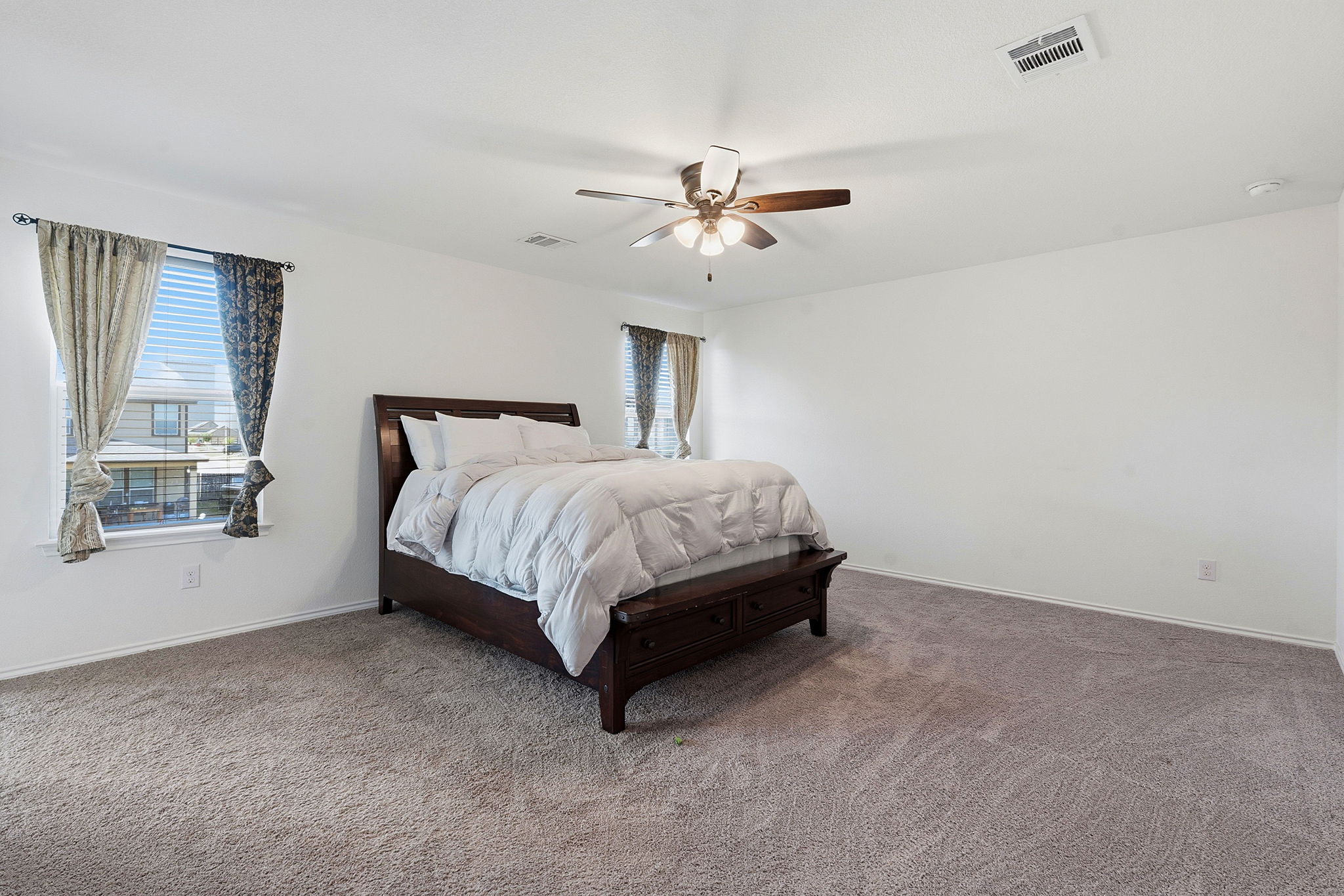 13928 Inaugural Street Manor, TX 78653 - Photo 21 of 34 Large primary bedroom at the top of the stairs.
