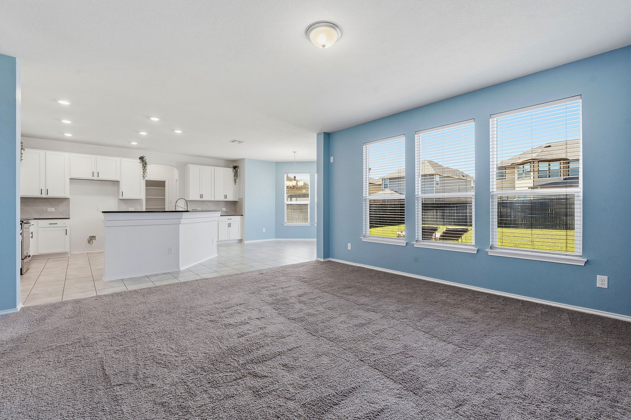 13928 Inaugural Street Manor, TX 78653 - Photo 7 of 34 Living room is open to kitchen and breakfast area.