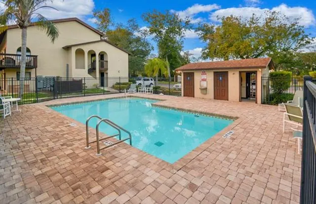 a swimming pool with outdoor seating and yard