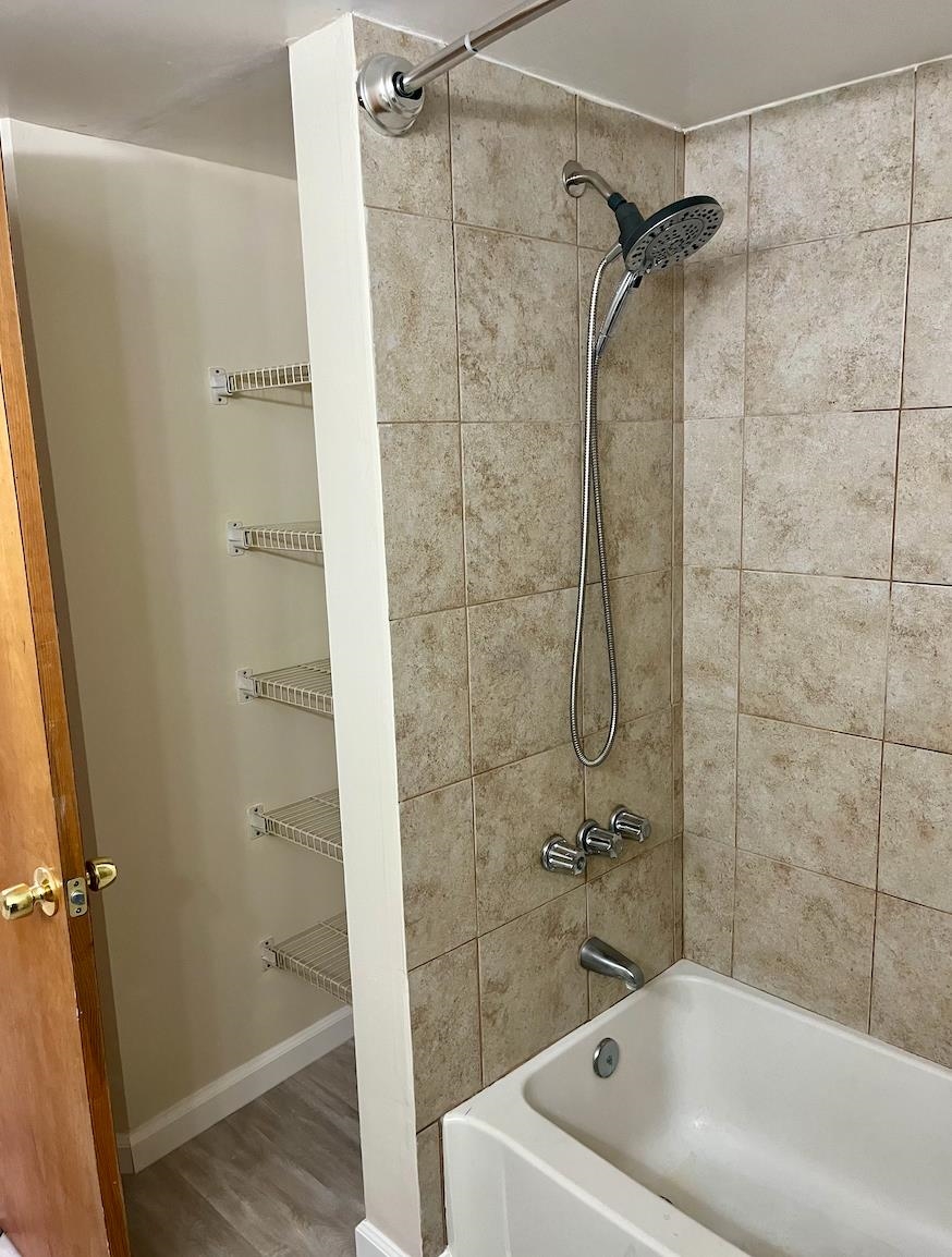 1255 Ponce Island Drive, Unit G787 St. Augustine, FL 32095 - Photo 11 of 14 a white bath tub sitting next to a white sink and vanity