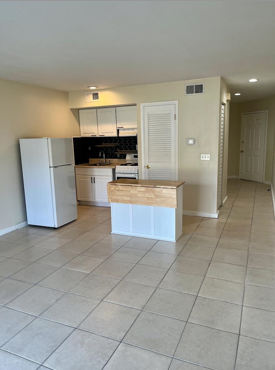 1255 Ponce Island Drive, Unit G787 St. Augustine, FL 32095 - Photo 2 of 14 a large kitchen with stainless steel appliances a stove a sink a microwave and a refrigerator