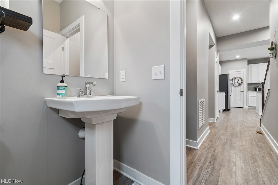 524 Oliver Way Rittman, OH 44270 - Photo 17 of 33 Bathroom with sink and wood-style floors
