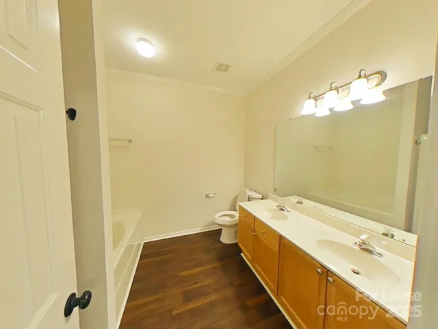 a bathroom with a double vanity sink and mirror with shower