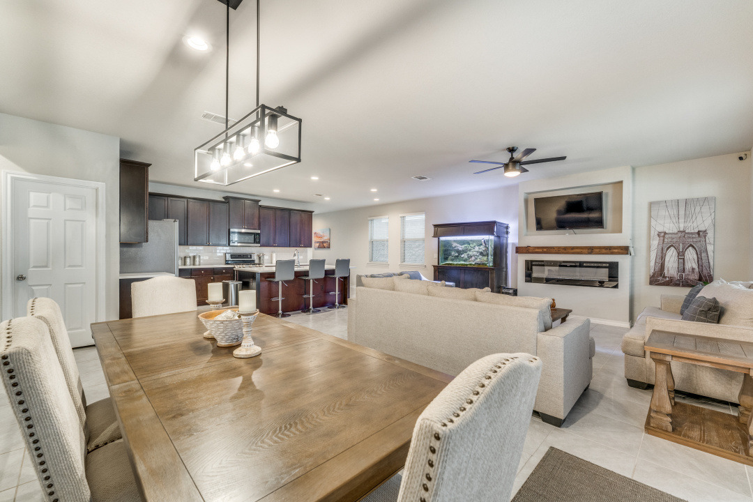 5921 Lehman Way Austin, TX 78747 - Photo 24 of 25 An open floorplan seamlessly connects the kitchen, dining, and living areas for modern living.