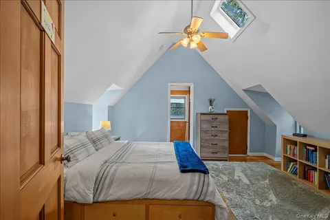 a bedroom with a bed and a book shelf