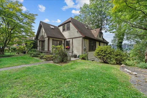 a view of a tree in front of a house