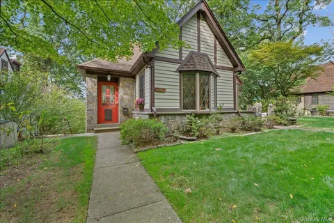 a front view of a house with garden