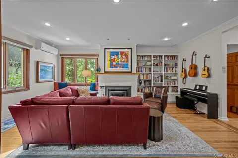 a living room with furniture a fireplace and a window