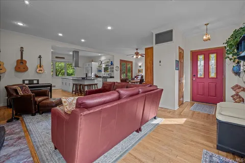 a living room with furniture a flat screen tv and a fireplace