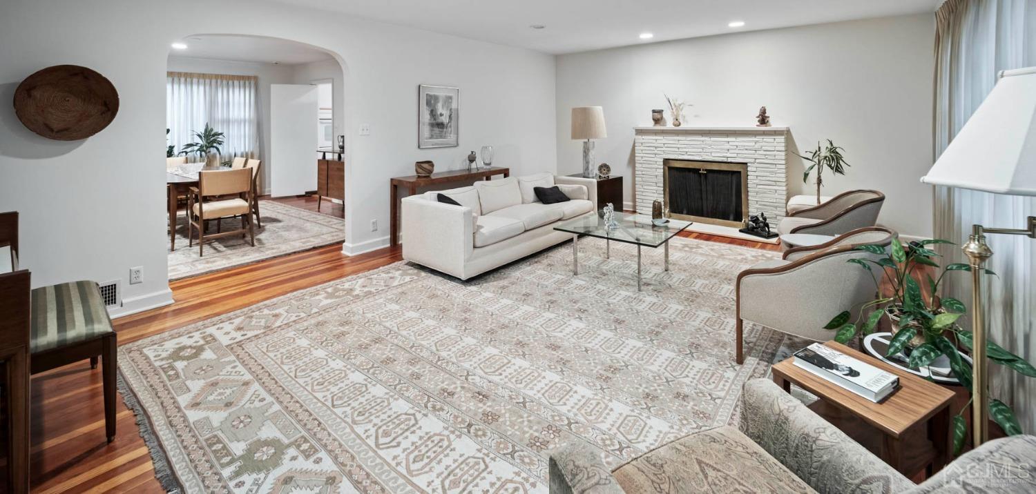 2 Beech Lane Edison, NJ 08820 - Photo 25 of 33 a living room with furniture a fireplace and a floor to ceiling window
