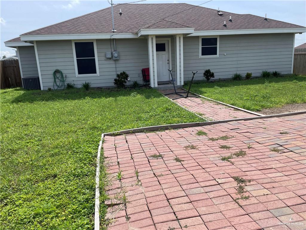 813 Blue Quail Street Alamo, TX 78516 - Photo 14 of 15 a front view of a house with a yard