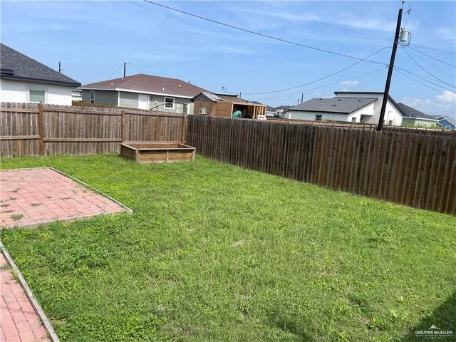 a view of a backyard with a garden and deck